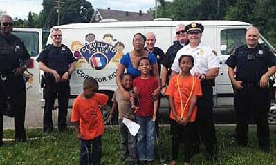 officers and children by cops for kids truck