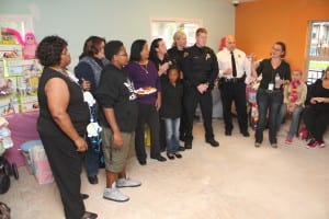 L to R: Retired Sgt. Hughlean Medlea and her grandson Shalom, retired Sgt. Sue A. Sazima, Sgt. Zina Martinez, PO Patty Katynski who is in front of young Waverly, PO Dymphna O’Neil, PO Sean Schuler, Commander Sulzer, and Providence House Executive Director Natalie Leek-Nelson. 