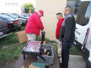 Members of the C.P.D. Ordnance Unit check the weapons in before they are cataloged.