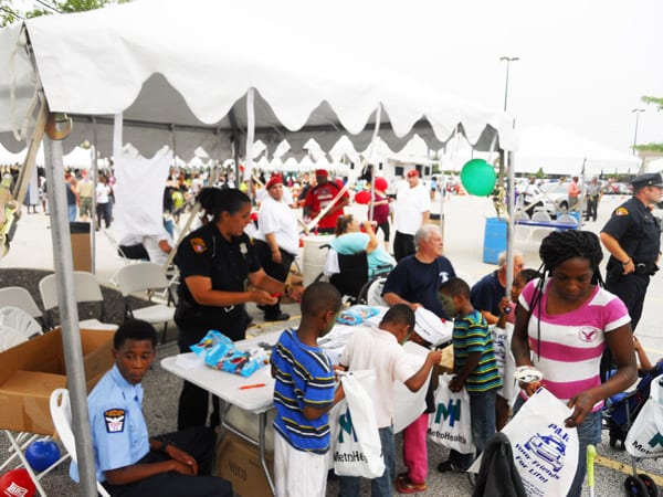 Children visit the tent manned by Community Policing Officers and receive handouts and safety tips from them.