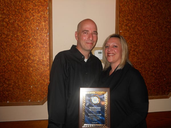 Mr. and Mrs. Henry Adkins pose with his plaque presented by The Cleveland Police Foundation for Outstanding Police Officer.