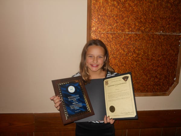 A very special young lady named Destiny Rice displays her Cleveland Police Foundation's Outstanding Individual Community Service Award.