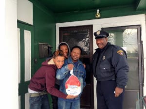 Officer Sam Anderson delivering a turkey in the Hough neighborhood in the 3rd District.