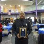 Patrolman Xavier Lynch, a 20 year veteran of the Cleveland Division of Police, displays his Cleveland Police Foundation's Community Service Award, for his outstanding service to both the citizens, and children of the 5th District. Officer Lynch also received The Commander's Commendation Award on this night.