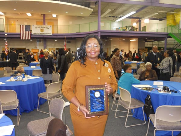Evangelist Sylvia Henderson Reeves, a community activist in her Glenville neighborhood, proudly displays her Community Service Award presented by The Cleveland Police Foundation.