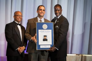 Mr. Joseph Mercado accepting the Patrol Officer of the Year award for his sister Patrol Officer Anna Mercado.