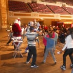 The boys and girls attending the P.A.L. party join Santa, and " The Rockin Robots" on stage for a dance session that seemed to go on forever.