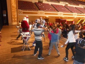 The boys and girls attending the P.A.L. party join Santa, and " The Rockin Robots" on stage for a dance session that seemed to go on forever.