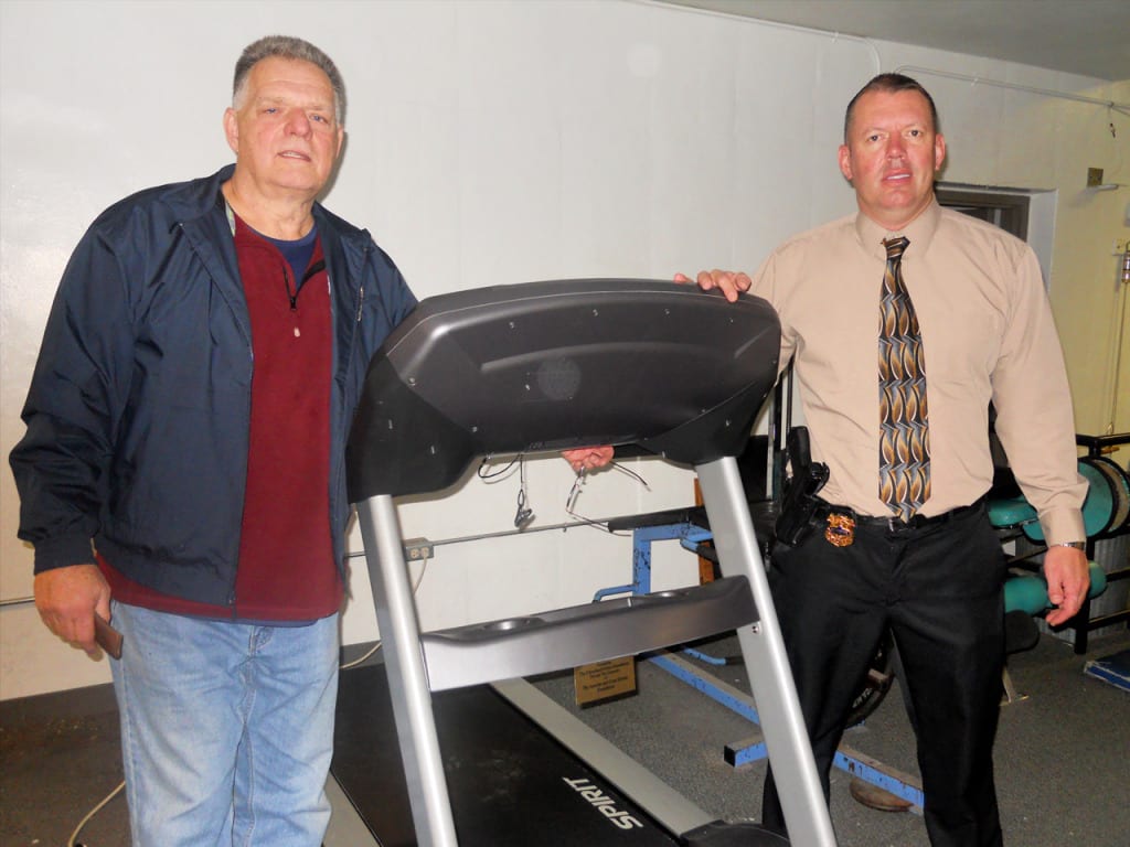 Cleveland Police Foundation Community Partnership Coordinator, Bob Guttu on the left, and Second District Detective, Bill Gonzalez, stand by the new addition to the Second District gym.