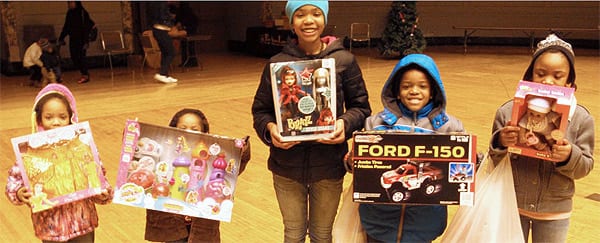 Children with holiday presents from PAL