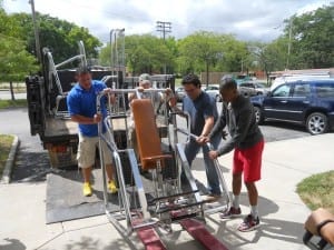 With help from the kids at the center and Officers from the First District, the machines are unloaded.