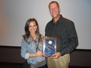Sara Carnes, and Len Howser of 95.5 " The Fish " proudly display their plaque.