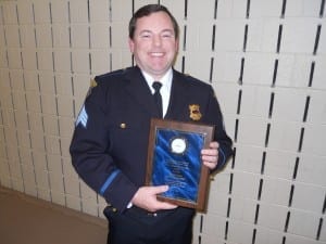 Sgt. Bryan Curry displays Burt Saltman's Award. (Burt was unable to attend)