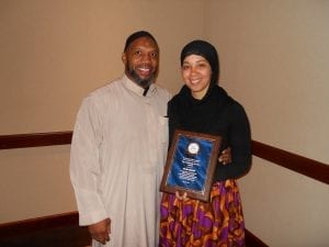 Akeesha Abdullah poses with her husband and her Community Service Award.