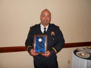 Captain John Sotomayor proudly displays his award.