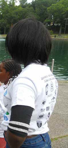 Adult volunteer with girl at Cops for Kids fishing outing event