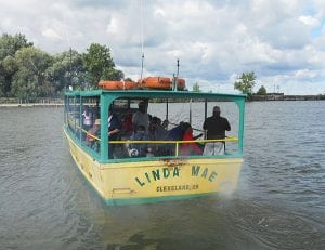 The Linda Mae heads out with an enthusiastic bunch of kids and officers.