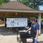 Officer Tim Riley preparing lunch for the kids after a hard day of fishing.