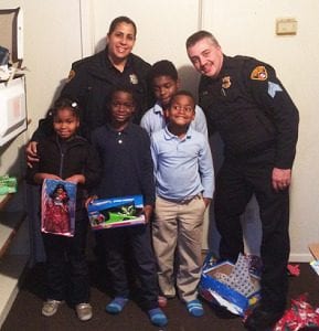 Members of the Davis family pose with PO Anna Mercado and Sgt. Tim Higgins. L to R: Daeshauna, Age 7; Deangelo, Age 9; Tyshawn, Age 8; and Antwjuan, Age 11.