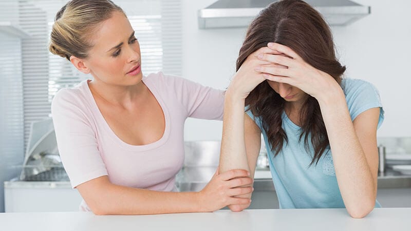 Woman comforting female friend