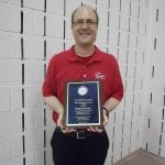 Matt Thornicroft, the representative from Pierre's Ice Cream displays their plaque.