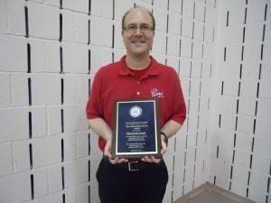 Matt Thornicroft, the representative from Pierre's Ice Cream displays their plaque.