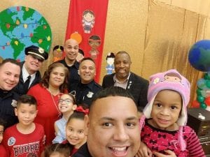 Officers pose with children in a school setting.