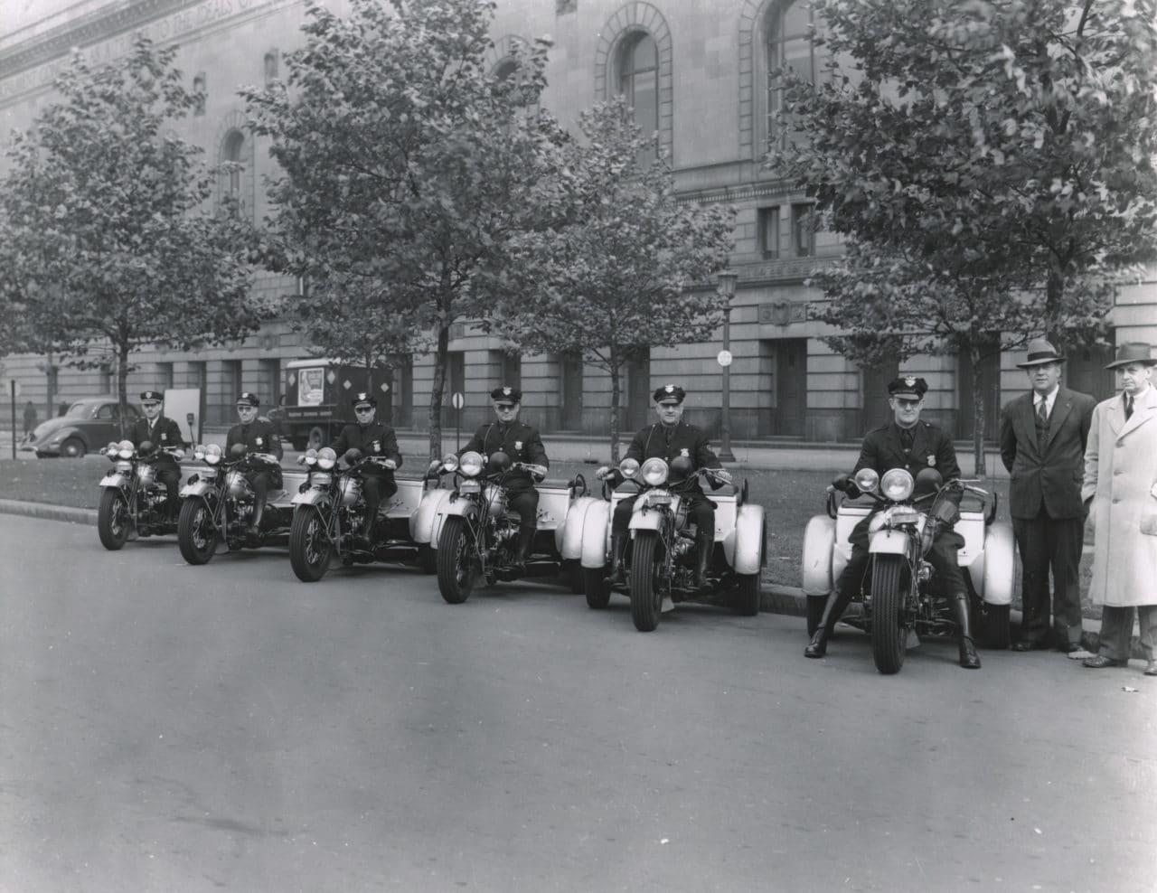 A photo of Eliot Ness inspecting a fleet of Harley-Davidson Servicars courtesy of the Cleveland Police Museum