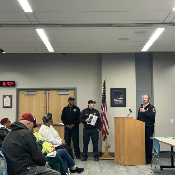 Cleveland Fire representatives stand by as a CFD speaker presents at the District 3 meeting.