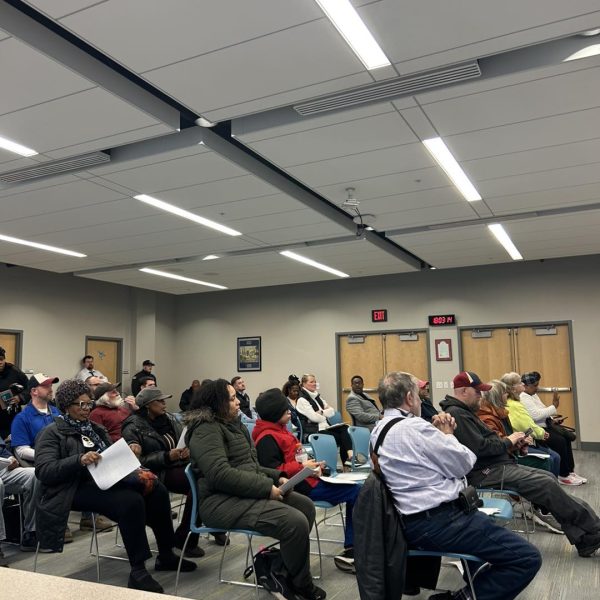 Community members seated and listening during the April District 3 Policing Committee meeting.