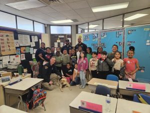 Scranton School students pose with DOP officers and a K-9 companion during the Easter celebration.
