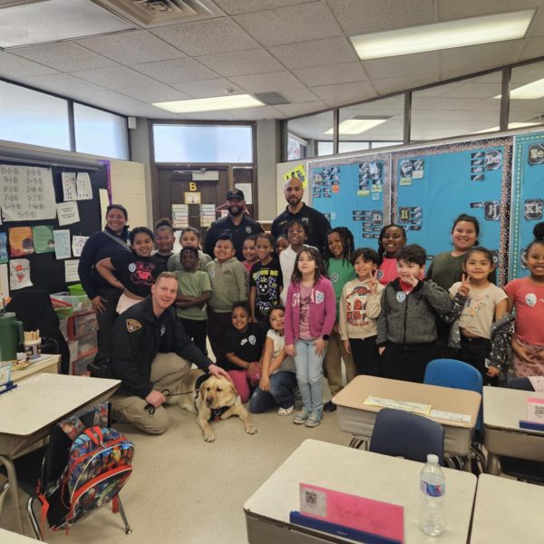 Scranton School students pose with DOP officers and a K-9 companion during the Easter celebration.