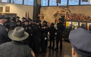 New Cleveland Police officers receive their badges during a pinning ceremony held at the Cleveland Police Museum.