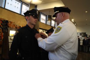 Lieutenant Rutherford pins the badge on his son, Patrol Officer Brennan Rutherford, at his graduation from CPD Academy Class 156.