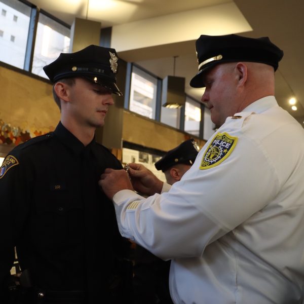 Lieutenant Rutherford pins the badge on his son, Patrol Officer Brennan Rutherford, at his graduation from CPD Academy Class 156.