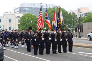 Cleveland Division of Police Honor Guard marches in formation carrying flags from Ohio, Cleveland, and allied agencies