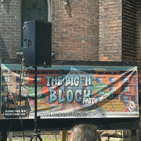 Outdoor banner for The Big “H” Block Party displayed on the side of a brick church building