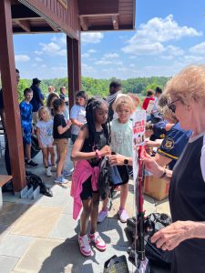 Kids line up to receive fishing rods and backpacks as giveaways during the event.