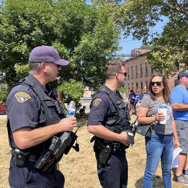 Officers and Councilwoman Santana talk during a stop at a neighborhood park