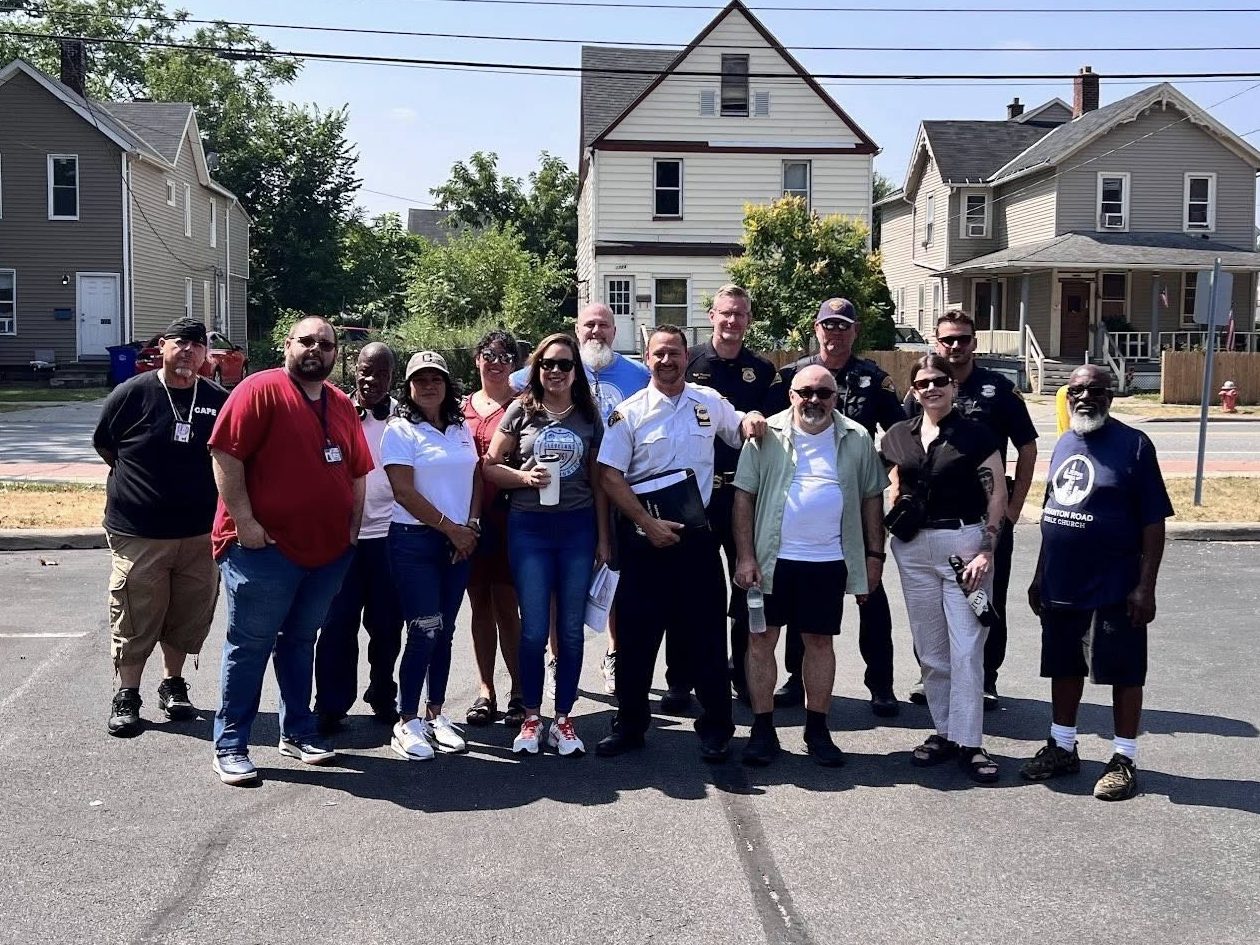 Officers and community members gather for a group photo during the District 2 safety walk