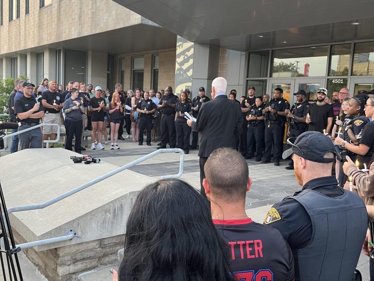 A crowd of officers and community members gathers outside the 3rd District for the vigil honoring Officer Jamieson Ritter.