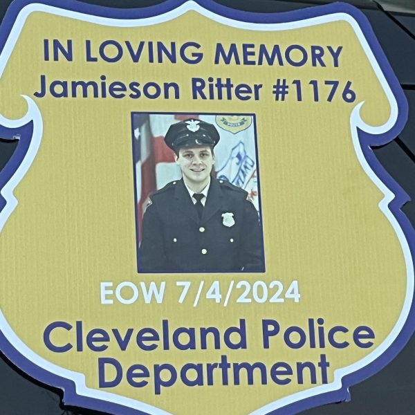 Close-up of the memorial badge honoring Officer Jamieson Ritter on the front of the patrol vehicle.