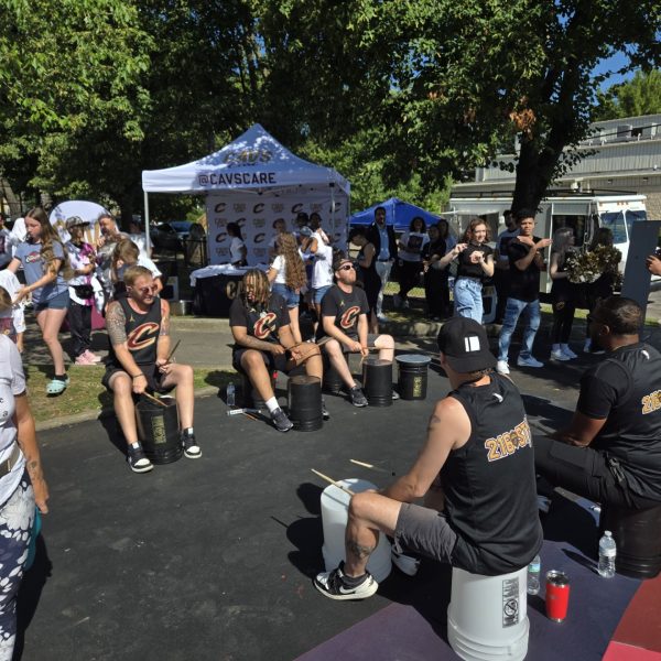 Members of the Cavaliers 216Stix drumline perform for a crowd during the Trent Park celebration.