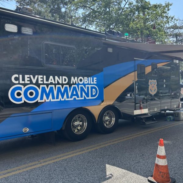 The Cleveland Police Division’s large blue-and-gold Mobile Command vehicle is parked on the street during the Feast of the Assumption.