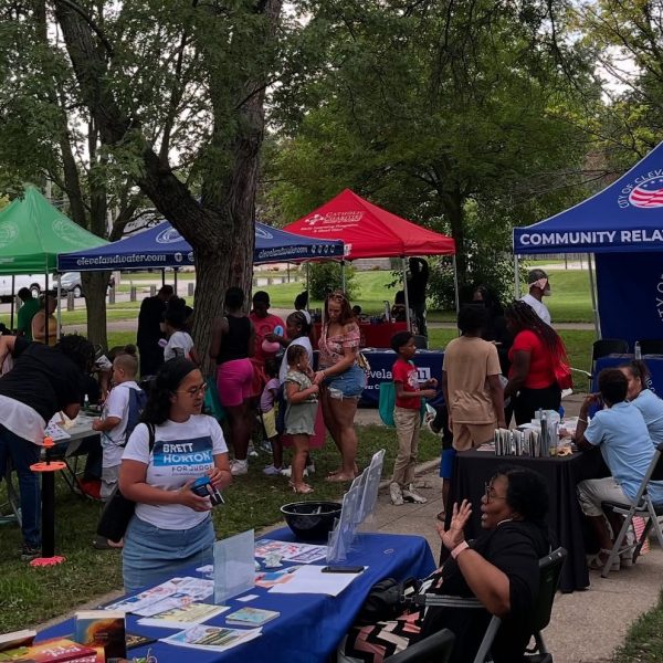 Community members gather around tables and tents set up by the Cleveland Community Relations Board and local organizations during National Night Out at Fairfax Recreation Center.