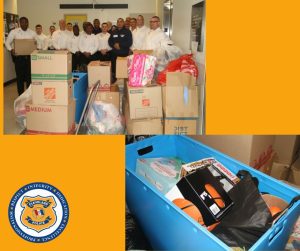 Police recruits stand behind stacks of boxes and bags of donated food, clothing, and toys, with a close-up of toys and supplies packed into a blue bin.