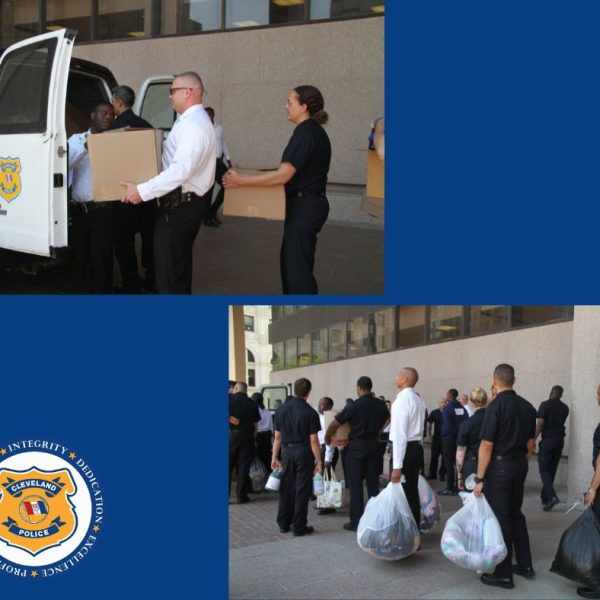 Police academy recruits load boxes and bags of donated items into a Cleveland Police van outside headquarters.