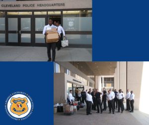 Recruits carry boxes and bags of donations out of Cleveland Police Headquarters, gathering in groups around piles of collected items.