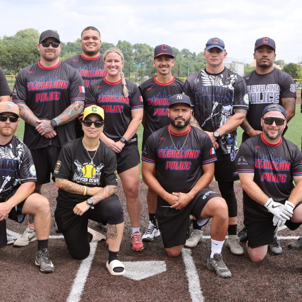 Cleveland Police softball team posing together on the field before the Police/Fire game.