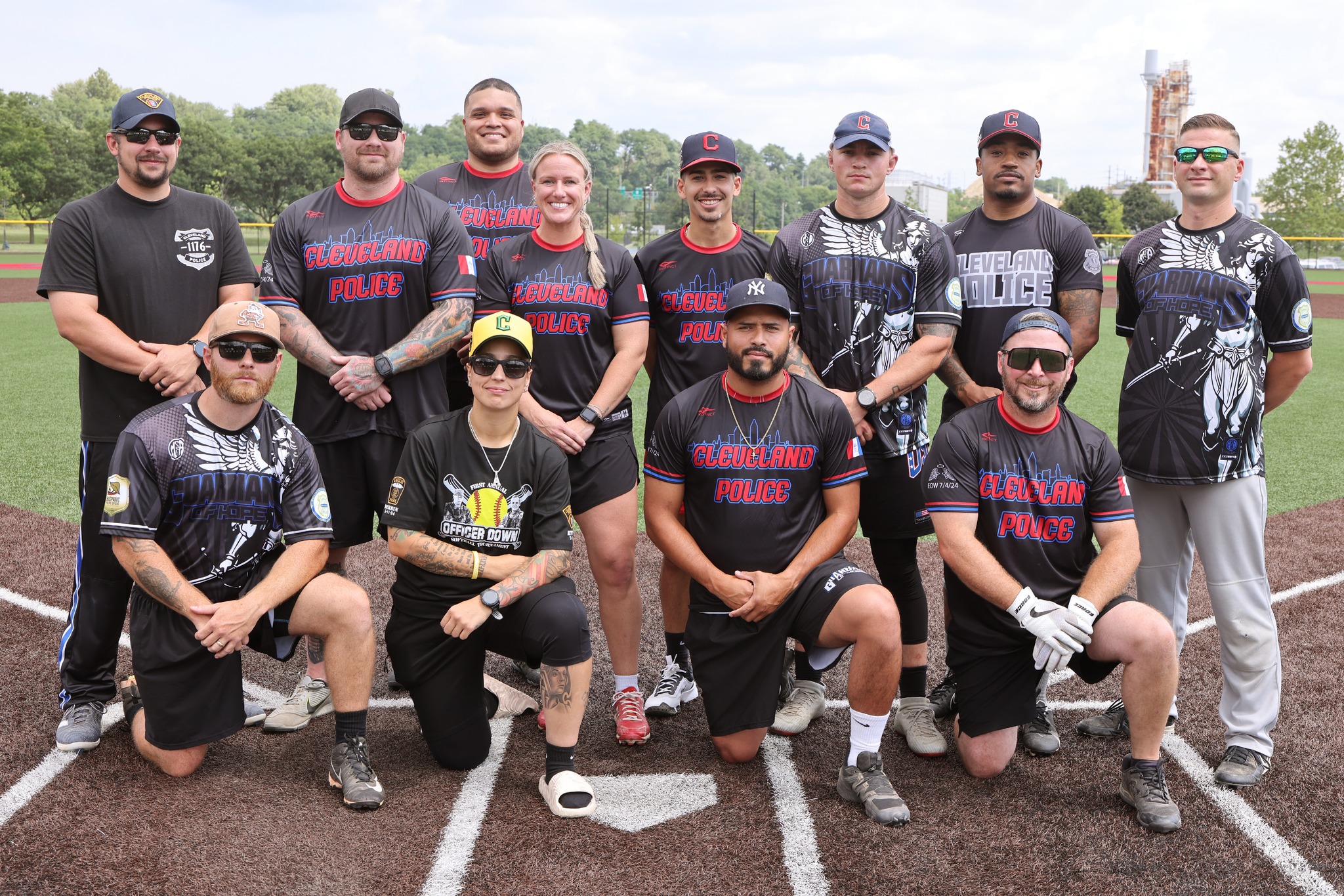 Cleveland Police softball team posing together on the field before the Police/Fire game.